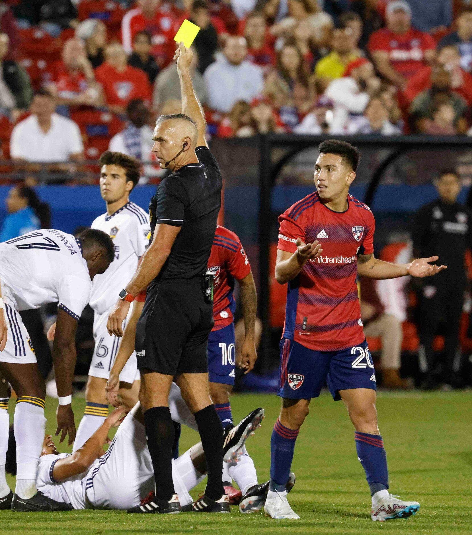 FC Dallas forward Alan Velasco is shown a yellow card for a bad foul during the second half...