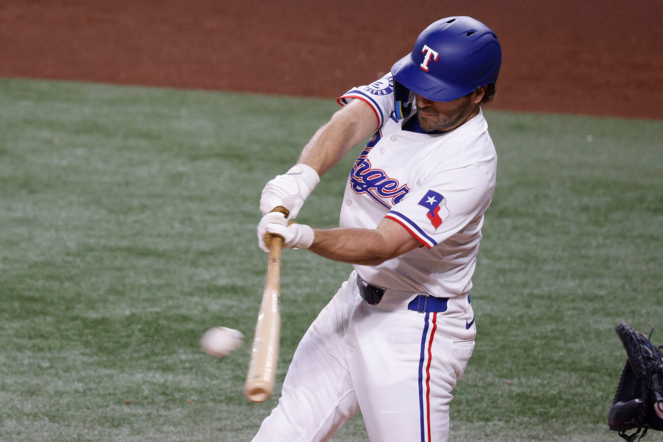 Texas Rangers shortstop Josh Smith (8) hits a double during the third inning of a baseball...