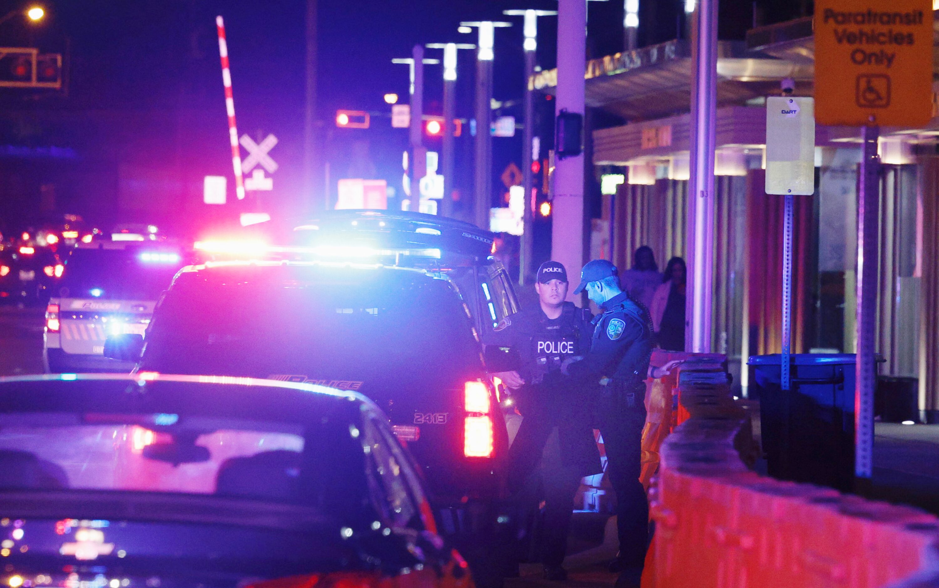 Dallas policemen stand guard after a shooting at the State Fair of Texas on Saturday night....