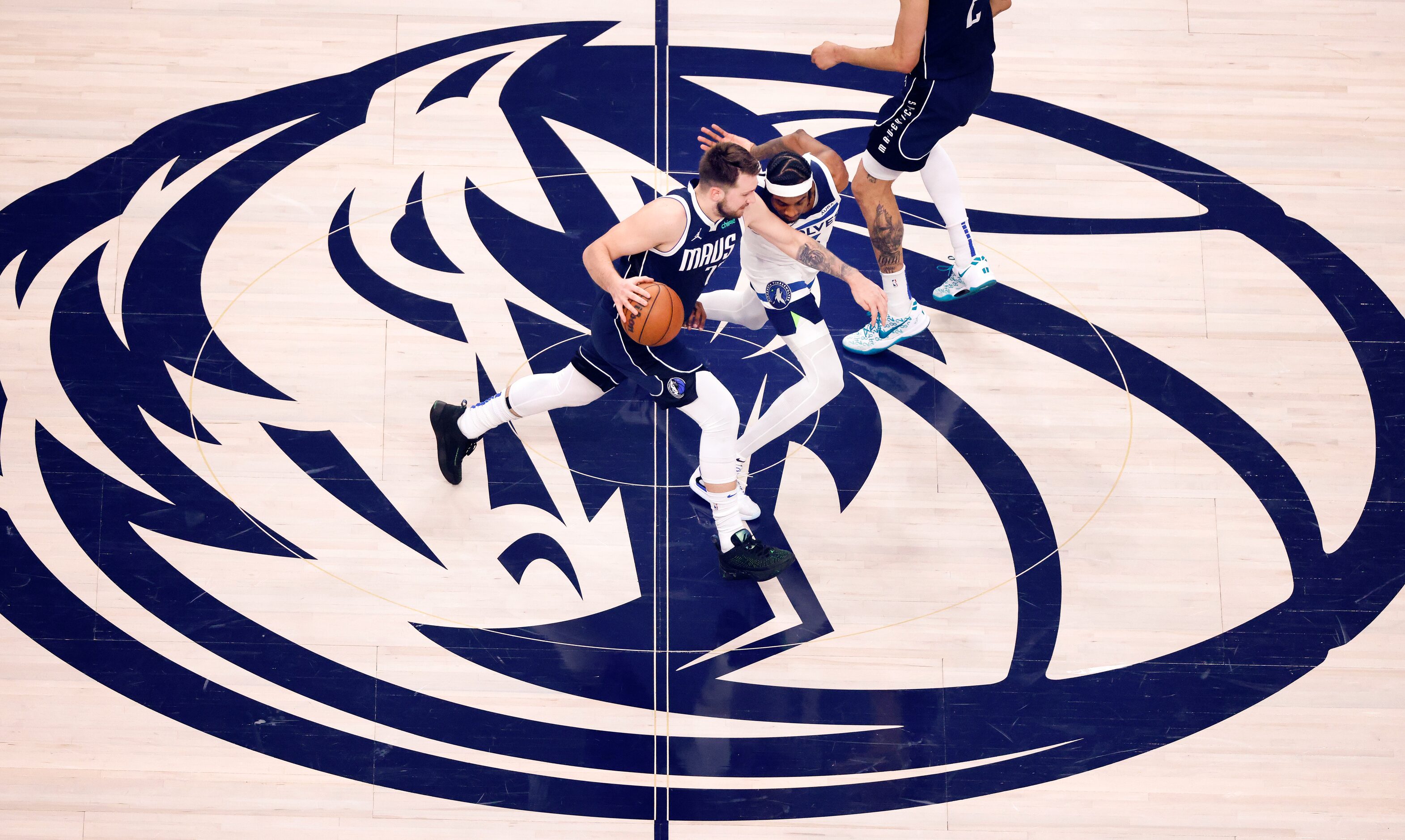 Dallas Mavericks guard Luka Doncic (77) dribbles past Minnesota Timberwolves forward Jaden...