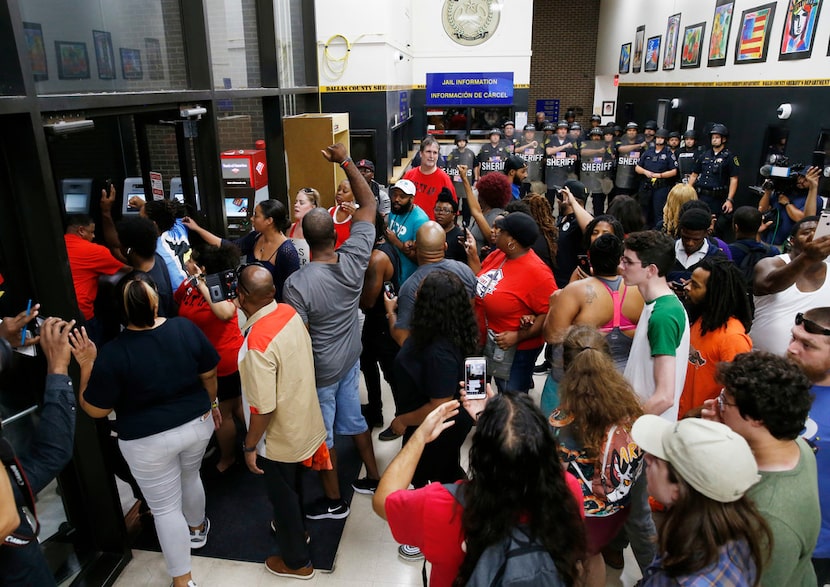 Protesters express their anger Wednesday after Amber Guyger was sentenced to 10 years in...