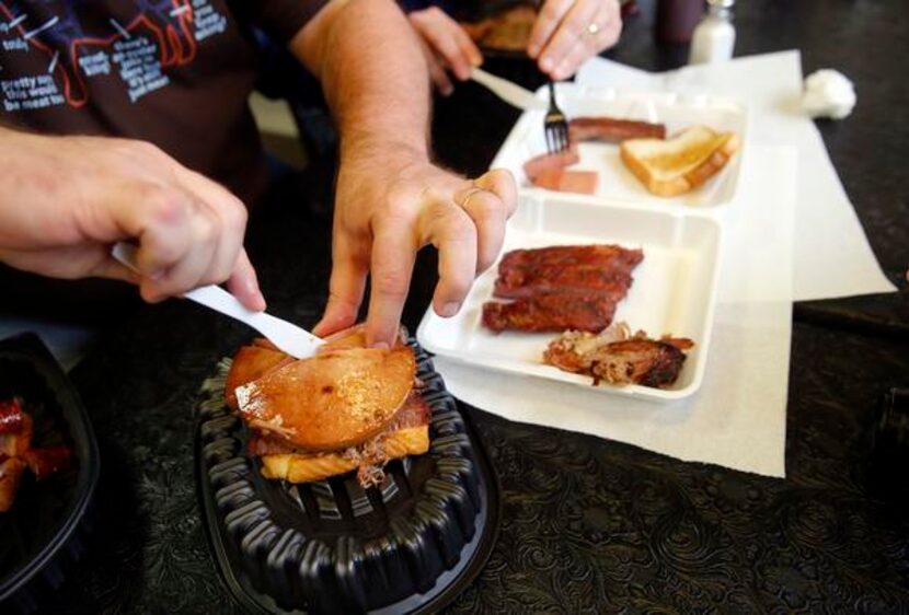 
The Texas BBQ Posse dismantles “The Jambo Texan” sandwich, piled high with brisket, chopped...