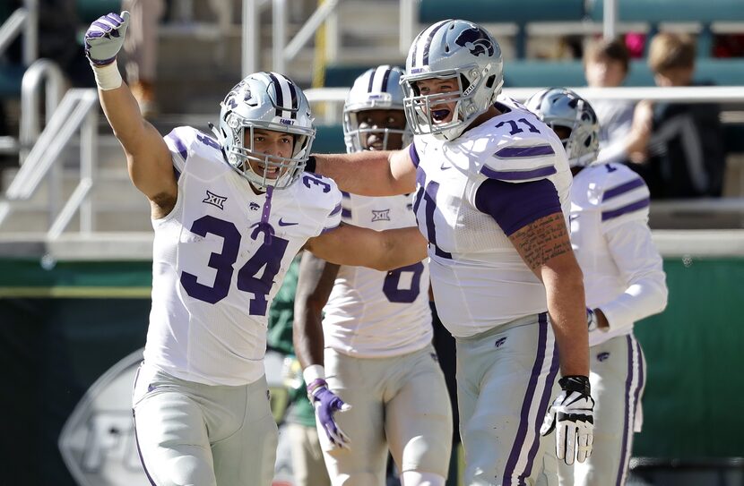 FILE - Kansas State's Alex Barnes (34) celebrates his touchdown with Dalton Risner (71)...