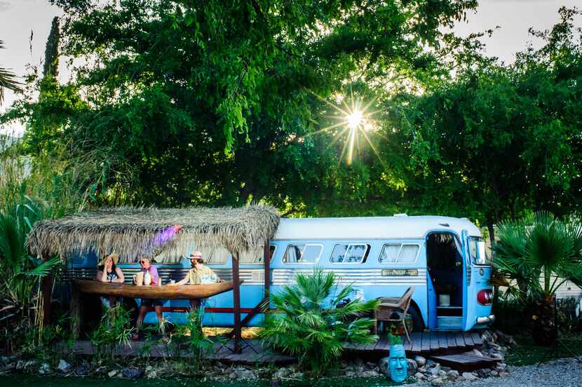 A bus is parked next to its own tiki bar at the Shady Dell Vintage Trailer Court in Bisbee,...