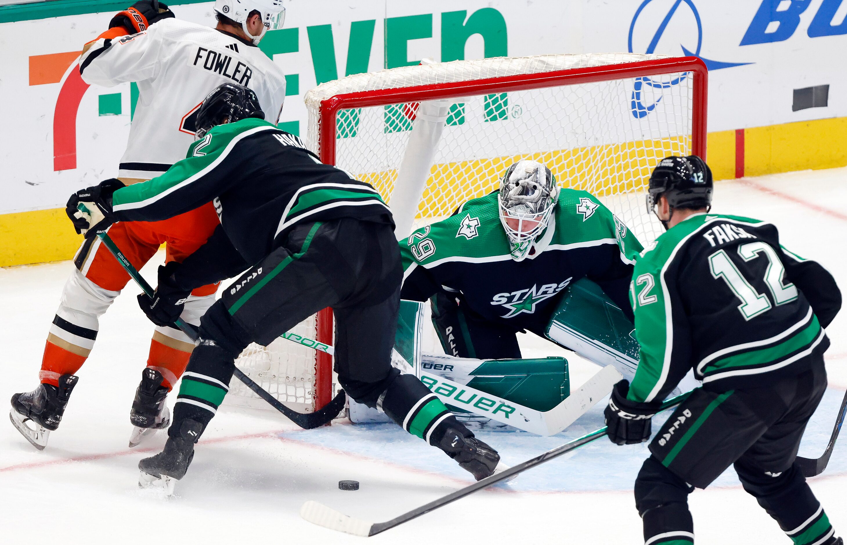 Dallas Stars goaltender Jake Oettinger (29) deflects a shot by Anaheim Ducks defenseman Cam...