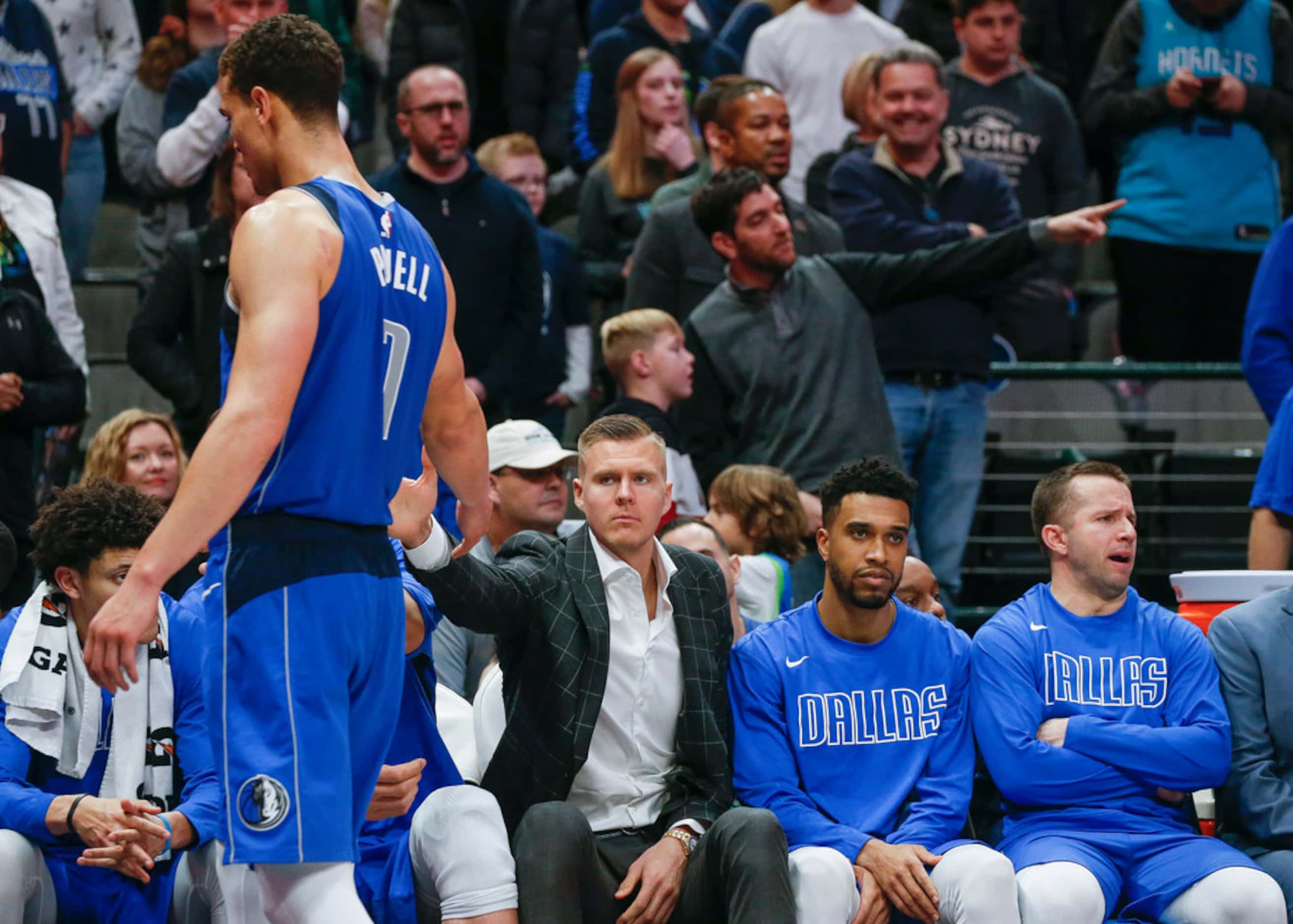 Dallas Mavericks forward Dwight Powell (7) takes a seat after fouling out during overtime in...