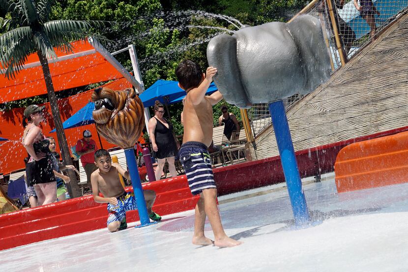 Matthew Esparza (9) and Christian Ross (5) play with the water cannons while visiting Safari...