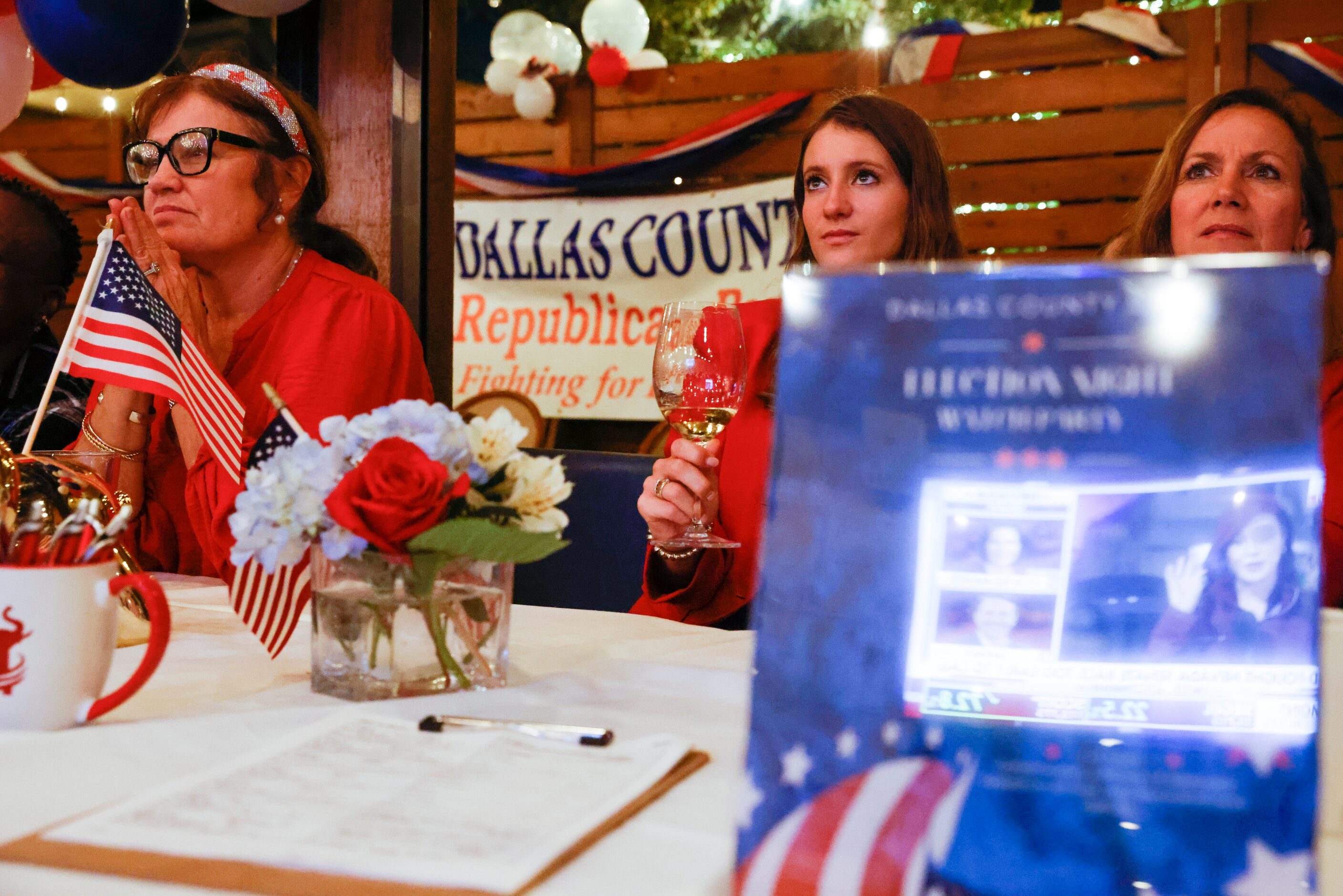 From left, Mary Brooks of Dallas, Beth and Michelle Copeland watch the electoral news during...