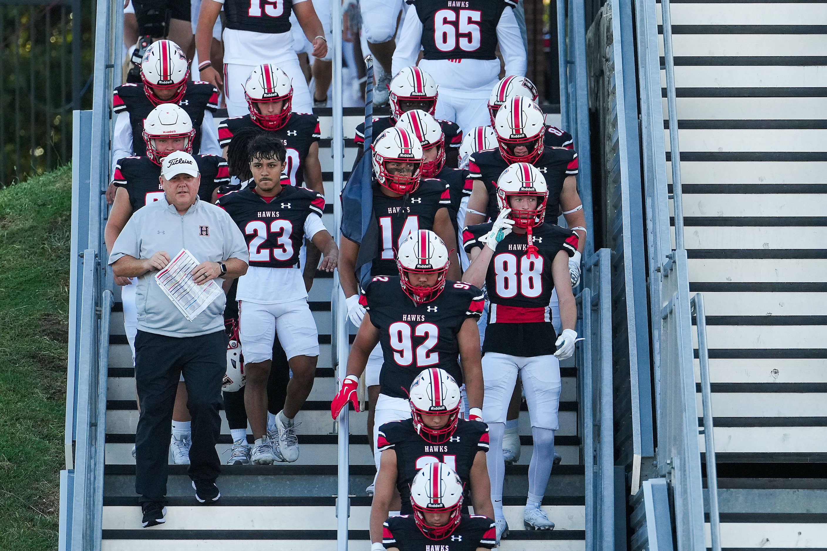 Rockwall-Heath head coach Rodney Webb joins his players as they take the field before the...