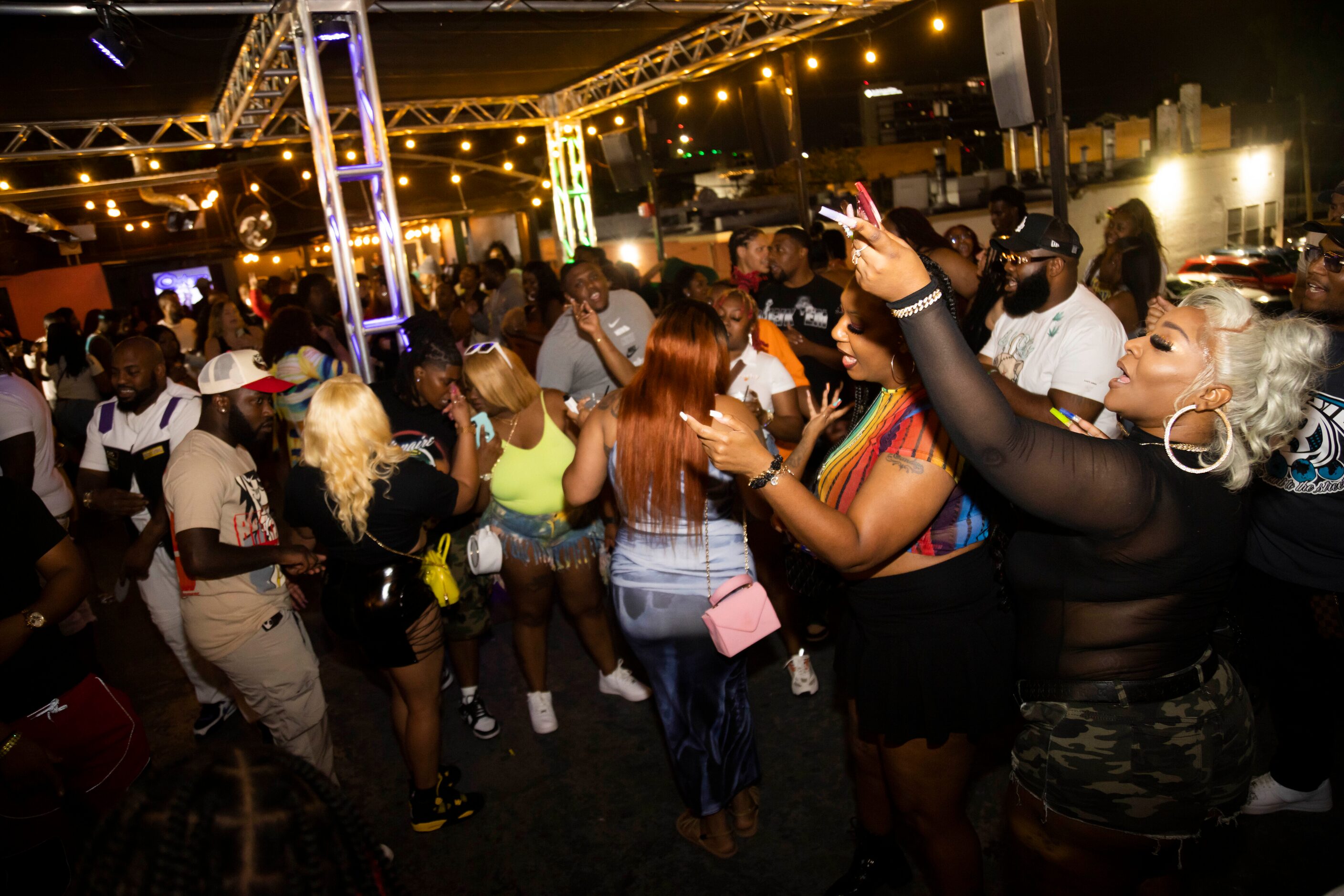 People dance on the rooftop of Nines in the Deep Ellum district of Dallas on Saturday, June...