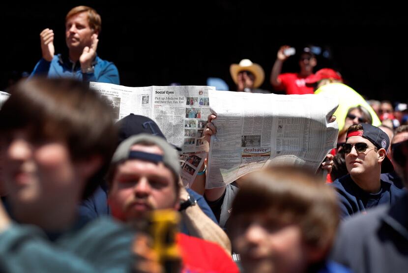 Texas Rangers fans react in different ways to Los Angeles Angels left fielder Josh...