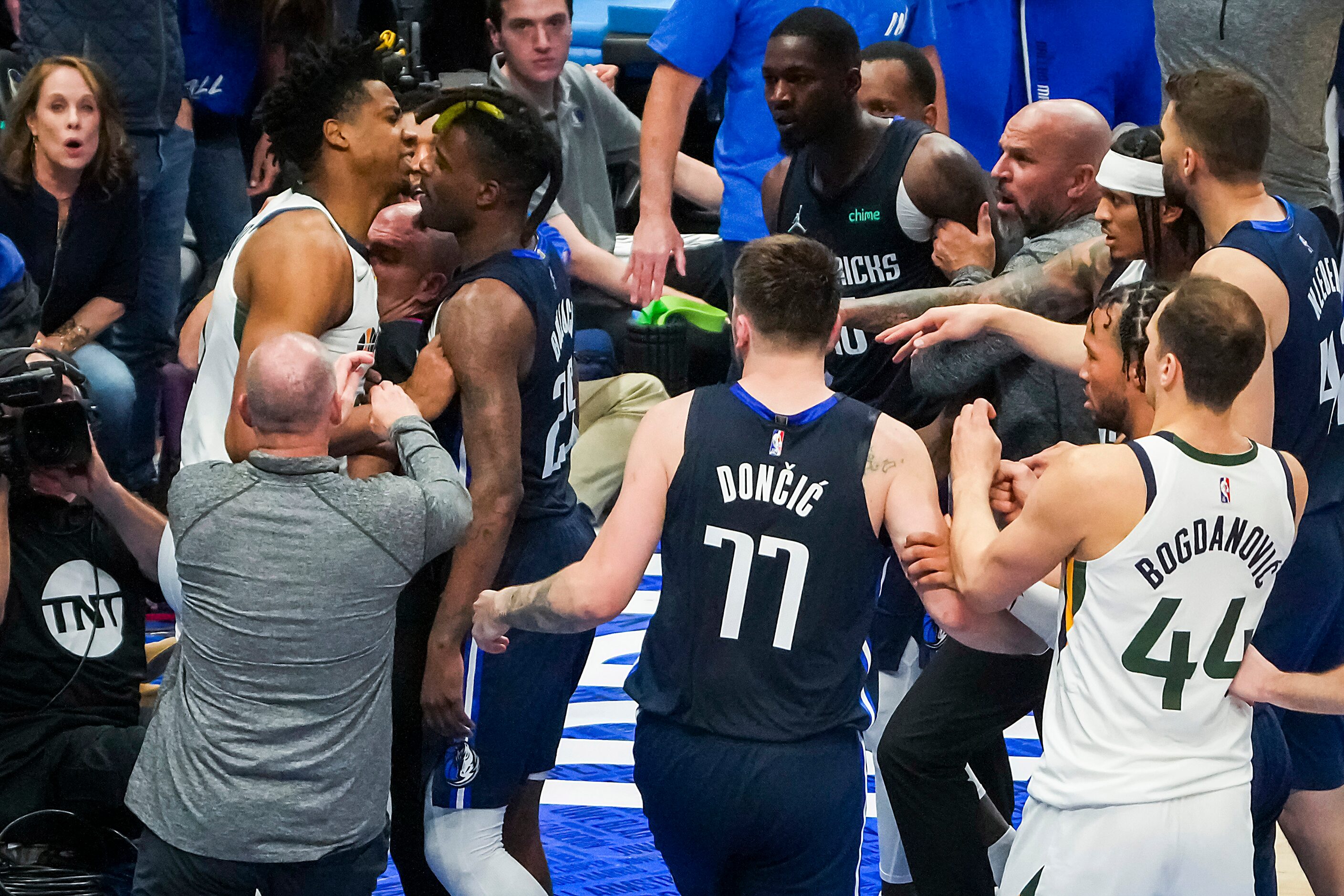 Players coaches and referees try to separate Dallas Mavericks forward Dorian Finney-Smith...