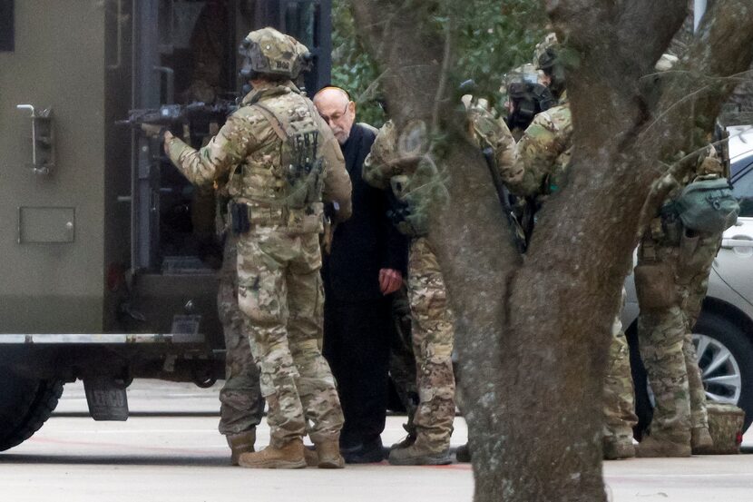 Members of the FBI escort a freed hostage at Congregation Beth Israel synagogue on Jan. 15.