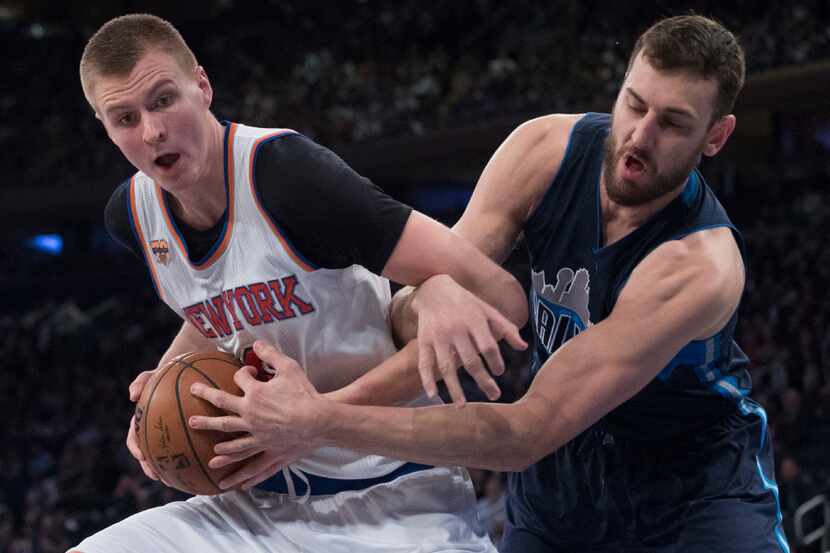 Dallas Mavericks center Andrew Bogut, right, fouls New York Knicks forward Kristaps...