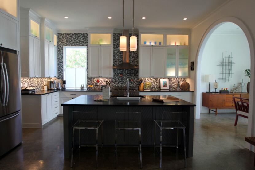A six-burner range adds a note of color to the kitchen. Polished concrete floors gleam...