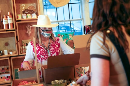 Owner Carley Seale (left) helped pack pick-up orders with Mary Walton at Favor The Kind on...