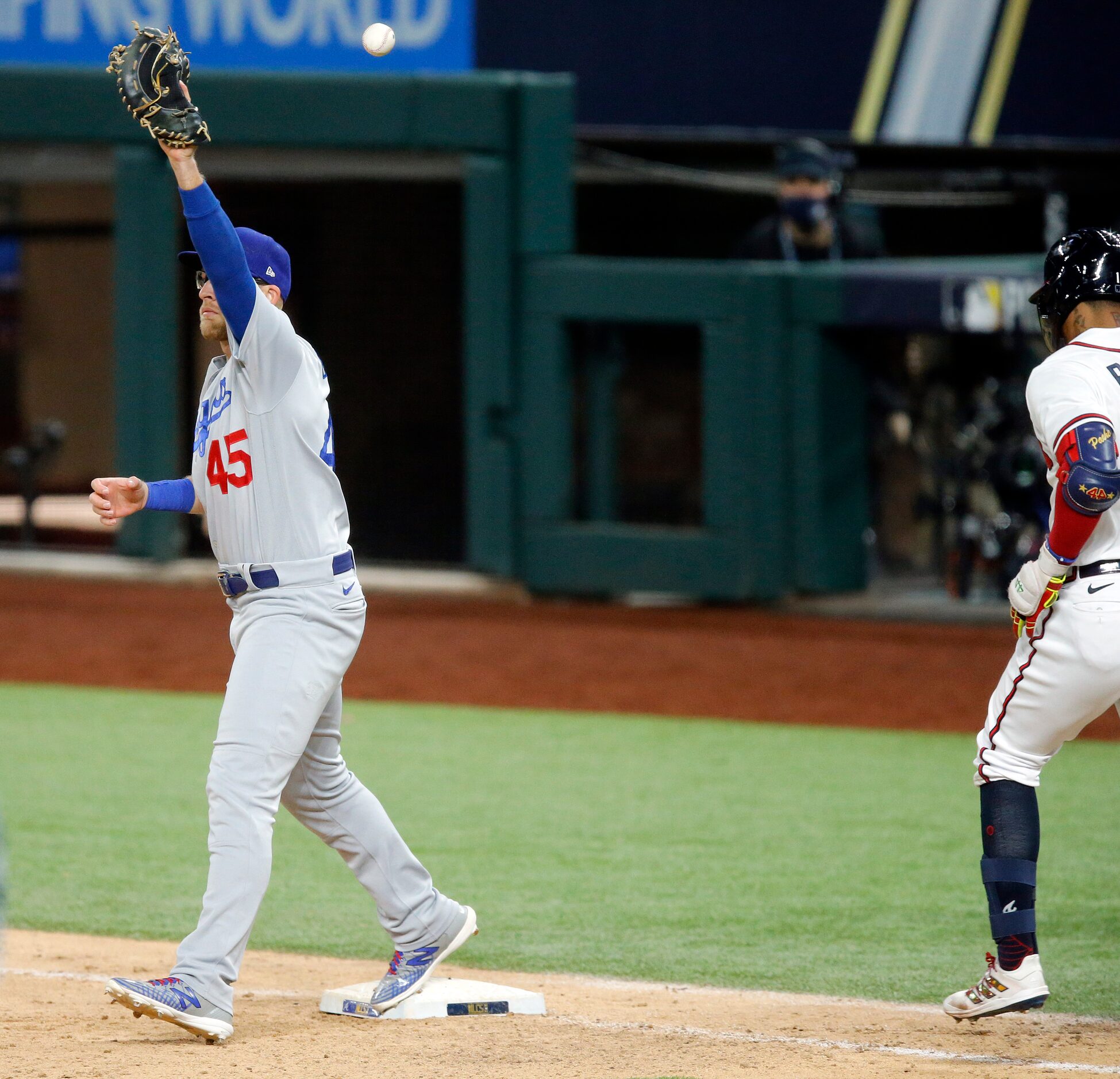 Los Angeles Dodgers first baseman Matt Beaty (45) misses a throw to first as Atlanta Braves...