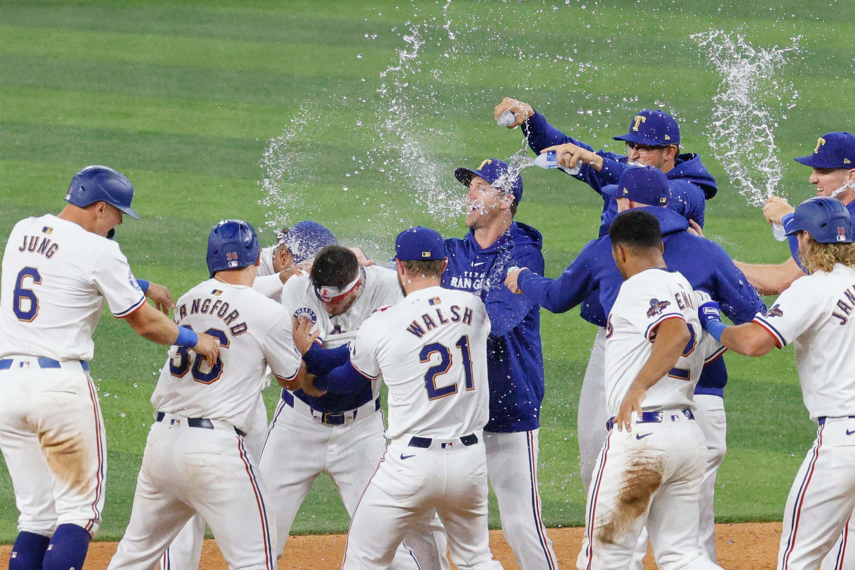 Texas Rangers players celebrate their victory against Chicago Cubs after an opening day...