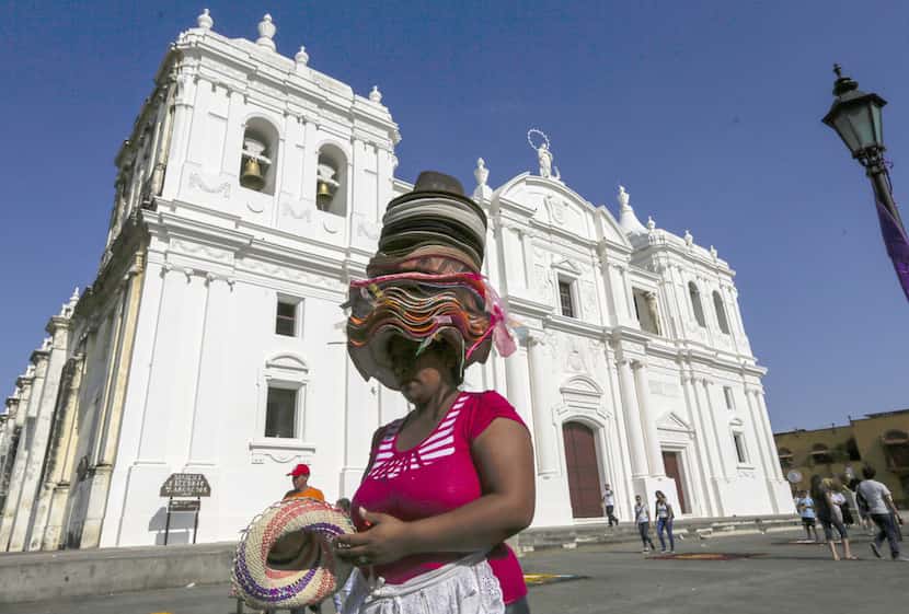 A vendor sells hats in front of the cathedral in Leon, Nicaragua, a good jumping-off point...