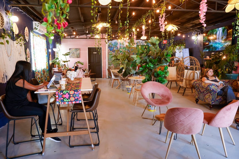 People sit and work at Cafe Frida, Tuesday, July 2, 2024, in Garland, Texas.