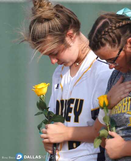 Forney manager Madison Galiano bows her head during a moment of silence for her sister Emily...