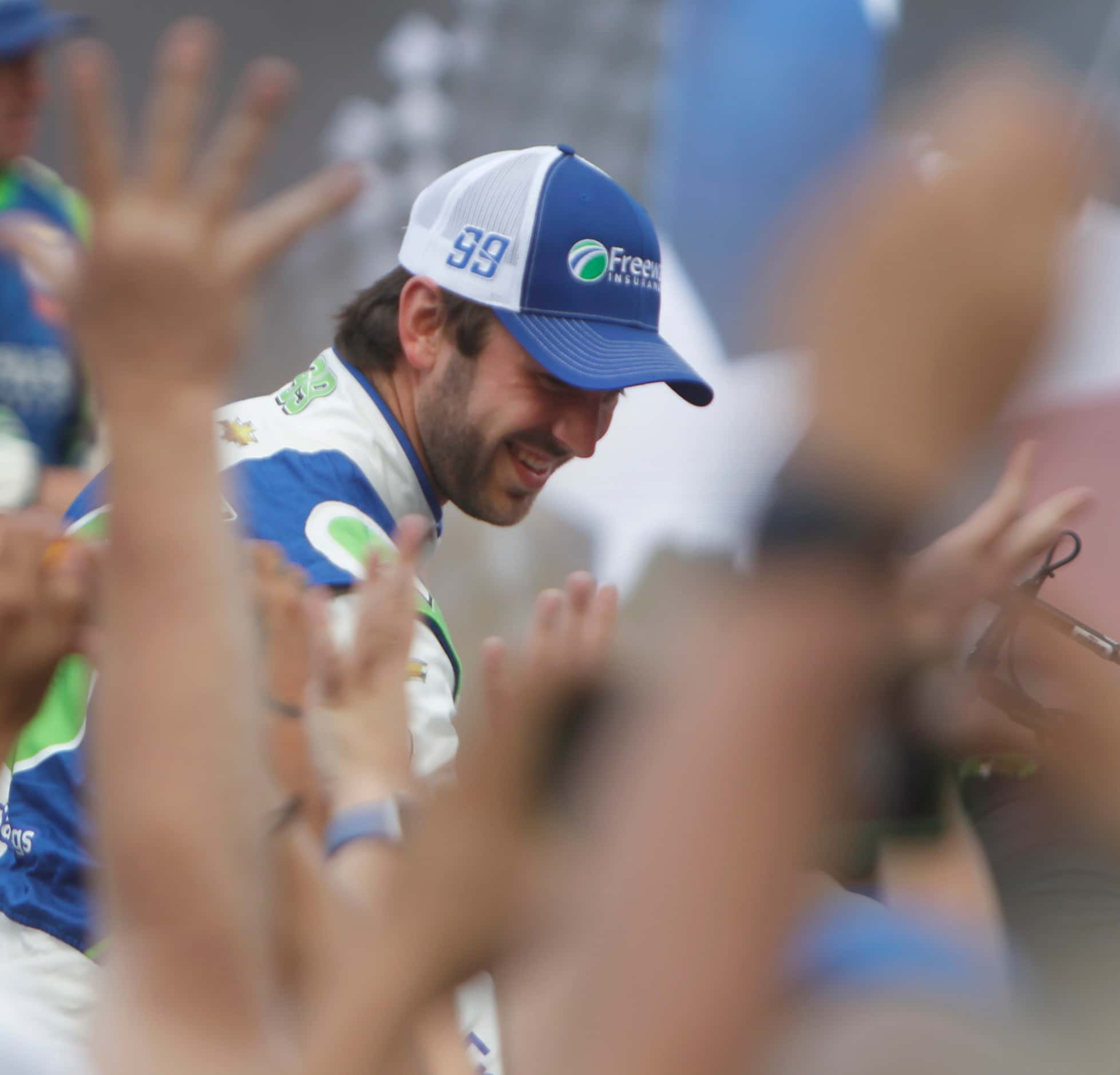 Daniel Suarez, driver of the #99 Freeway Insurance Chevrolet car greets enthusiastic fans...