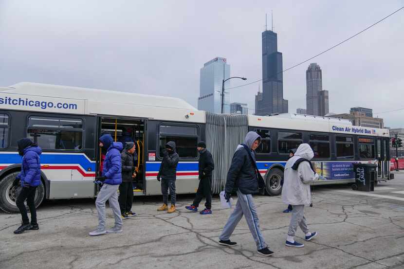 Chicago Transit Authority "warming" buses for migrants are parked in the 800 block of South...