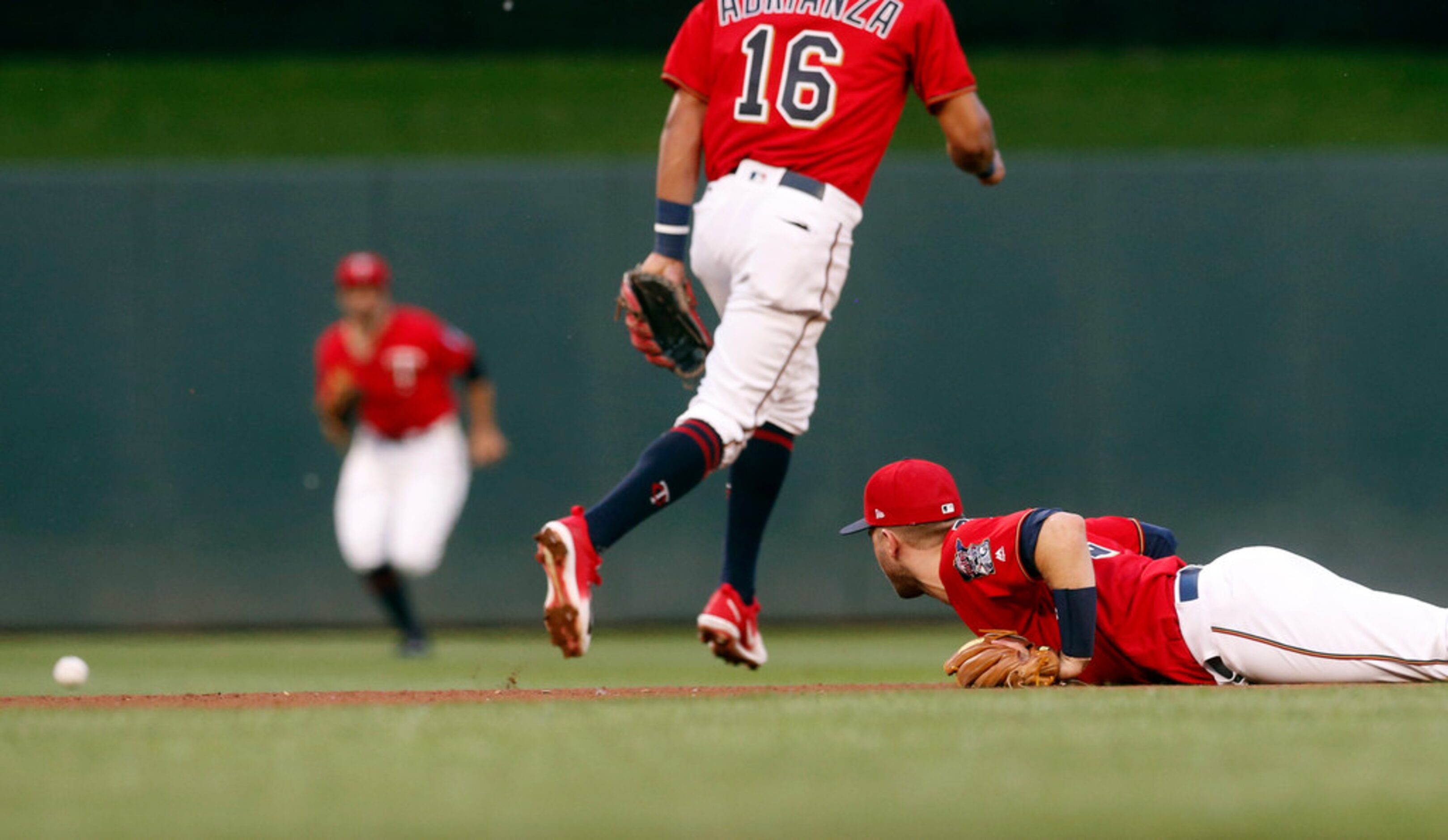 Minnesota Twins second baseman Brian Dozier, right, watches as a grounder by Texas Rangers'...