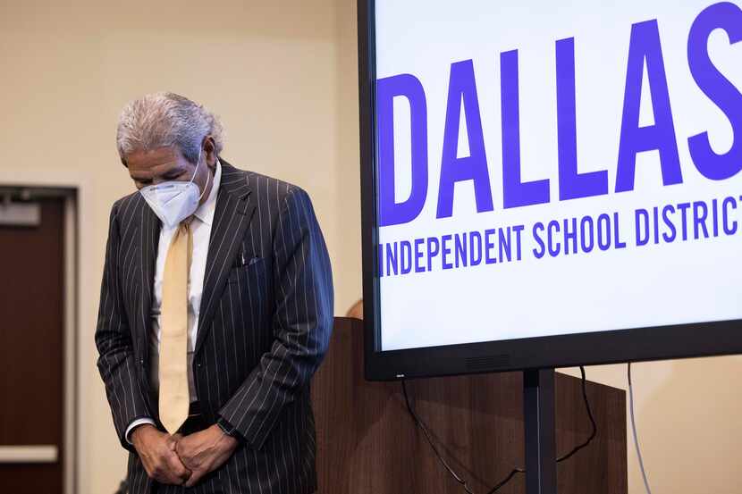 Dallas ISD’s superintendent Michael Hinojosa bows his head as Board Trustee Ben Mackey (not...