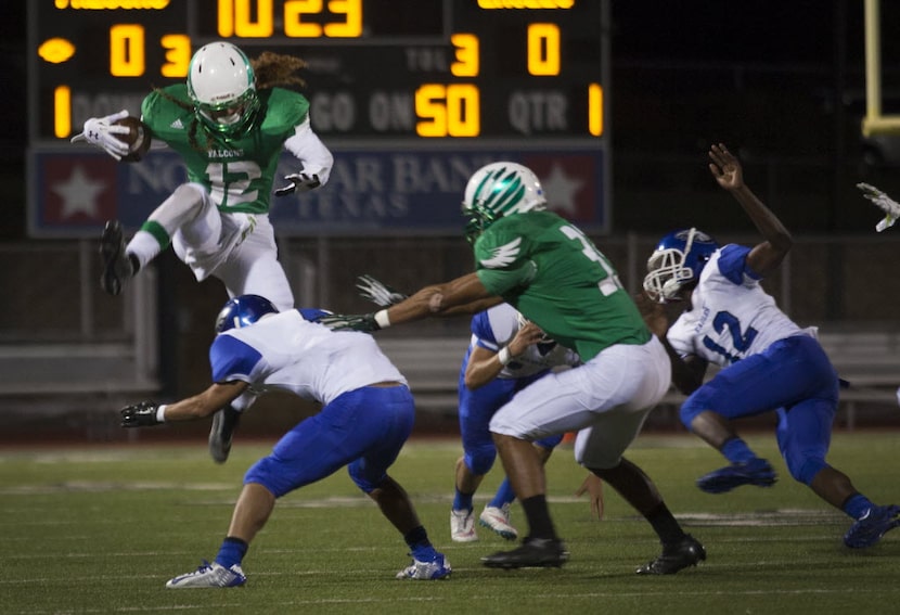 Lake Dallas senior wide receiver Keegan Brewer (12) jumps over Carter-Riverside senior...