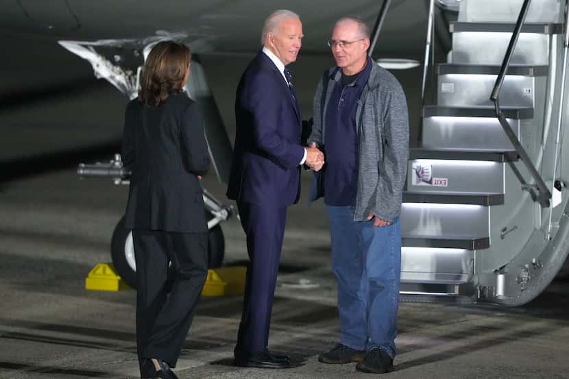 President Joe Biden, center, and Vice President Kamala Harris, left, greet Paul Whelan,...