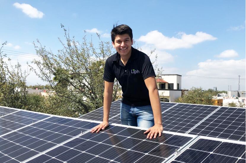 Jorge Diaz installs a solar panel.