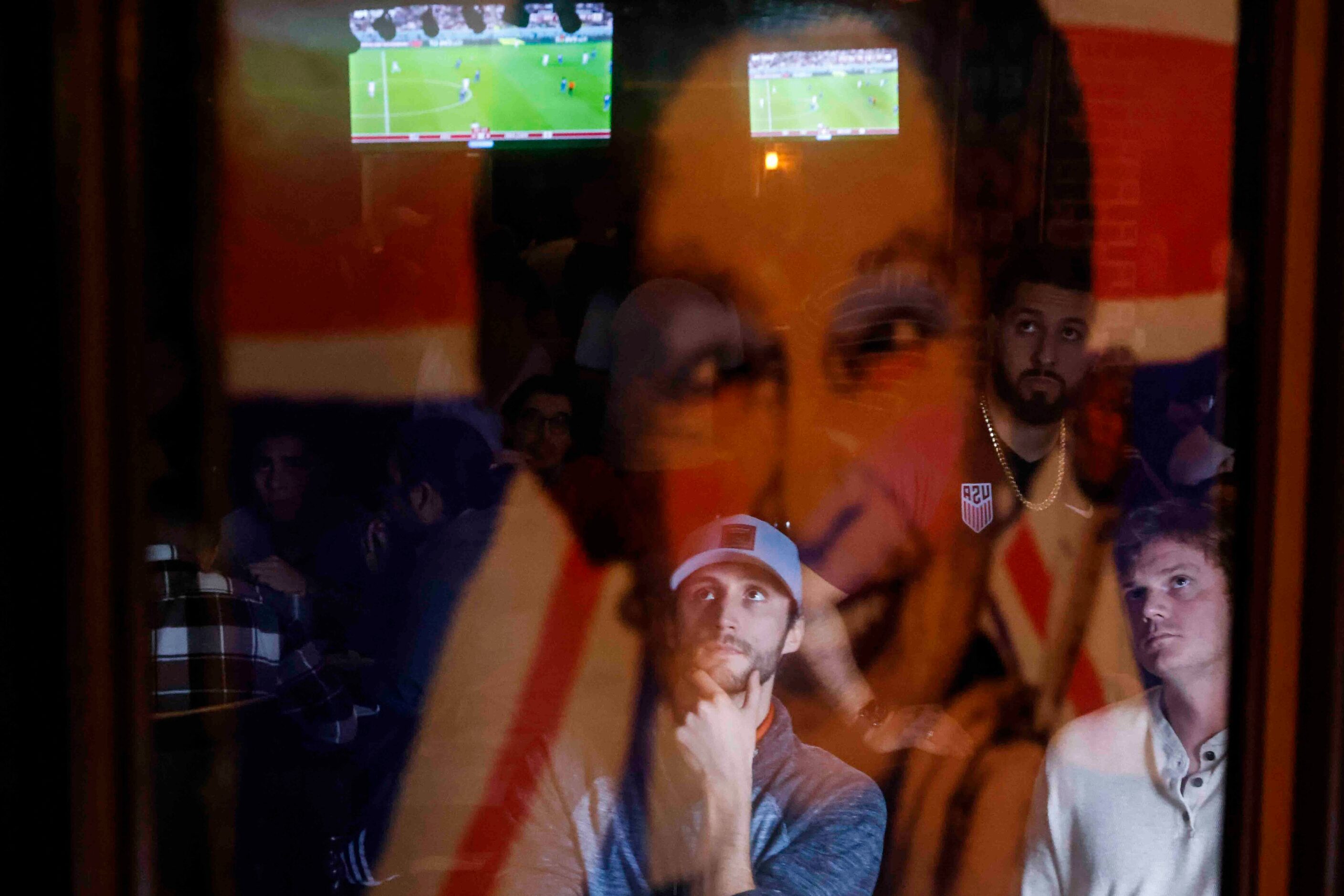 Trevis barber, left, and Charles Foose, of Dallas is reflected on a photo of late Britain's...