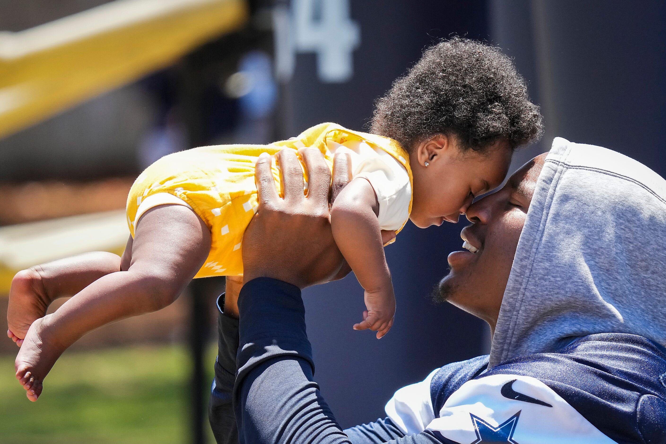 Dallas Cowboys defensive end Dorance Armstrong plays with his daughter Serenity after a...