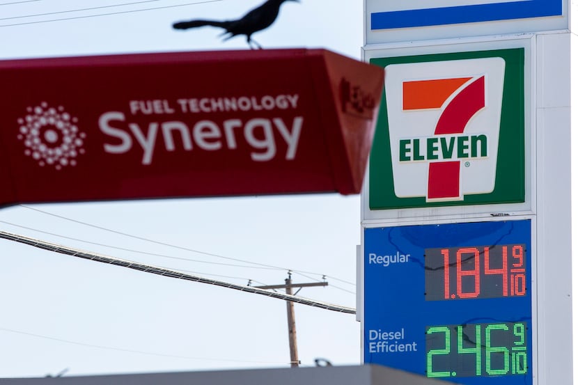 Signs advertise low gas prices at an Exxon gas station in Dallas on Thursday, March 12, 2020.