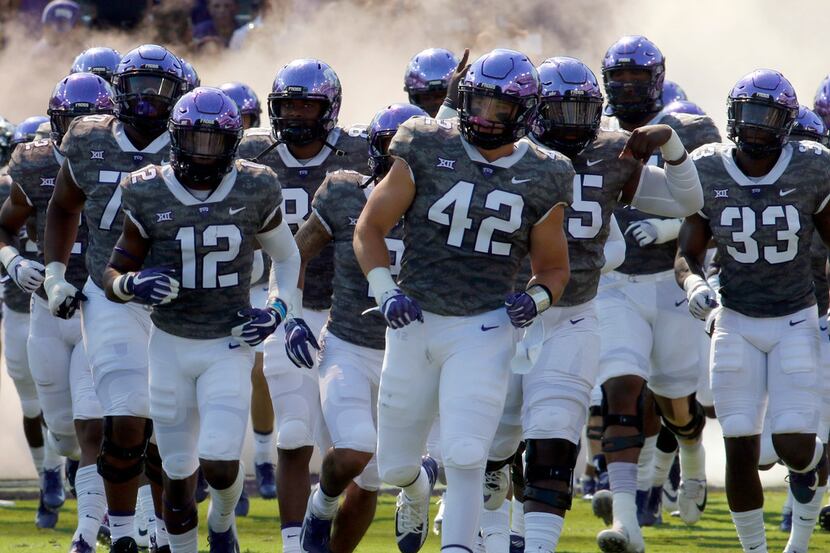 Members of the TCU horned frogs hit the field prior to the start of their game against...