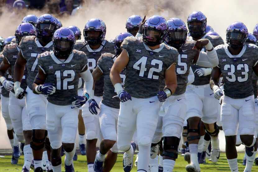 Members of the TCU horned frogs hit the field prior to the start of their game against...