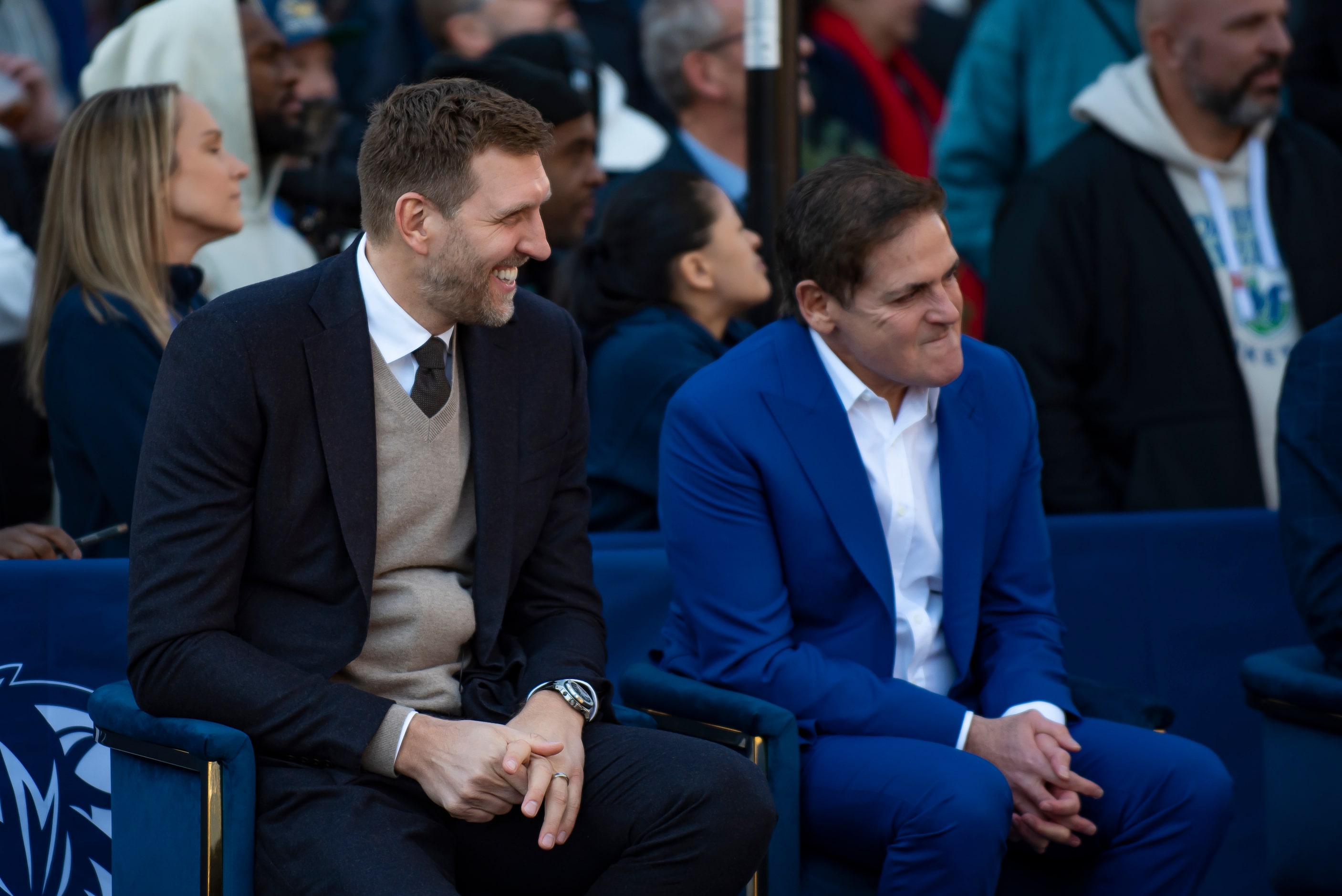 Dirk Nowitzki smiles while sitting next to Dallas Mavericks owner Mark Cuban during the "All...