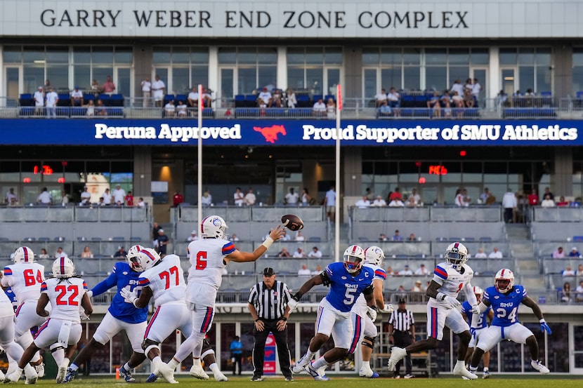 Houston Christian quarterback Cutter Stewart (6) throws a pass under pressure fromn SMU...