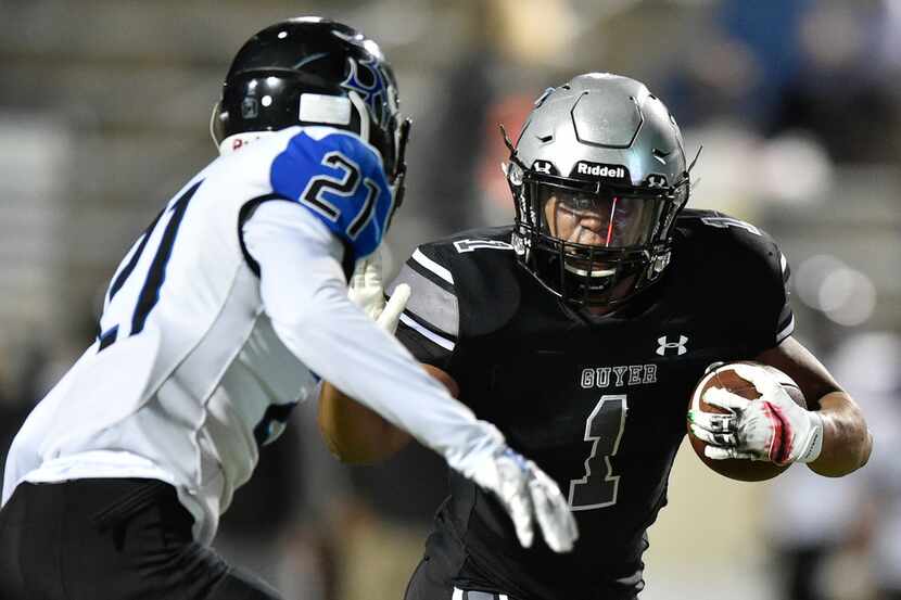 Guyer running back Kaedric Cobbs (1) rushes the ball, while being defended by Nelson's...