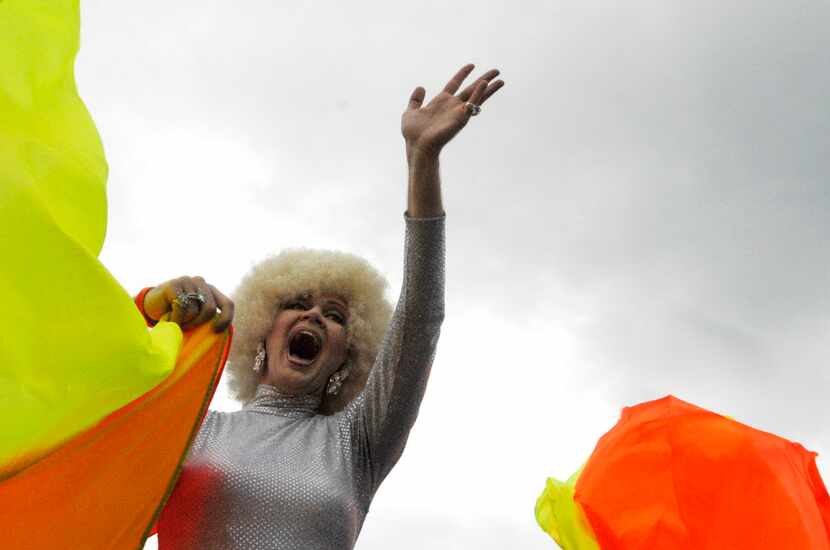 Rodd Gray, a.k.a. Patti Le Plae Safe, waves to the crowd during the Texas Freedom Parade and...