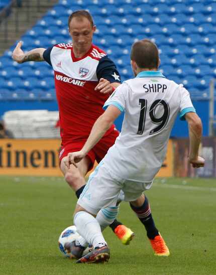 FC Dallas' Anton Nedyalkov (6) attempts to maneuver the ball around the defense of Seattle...