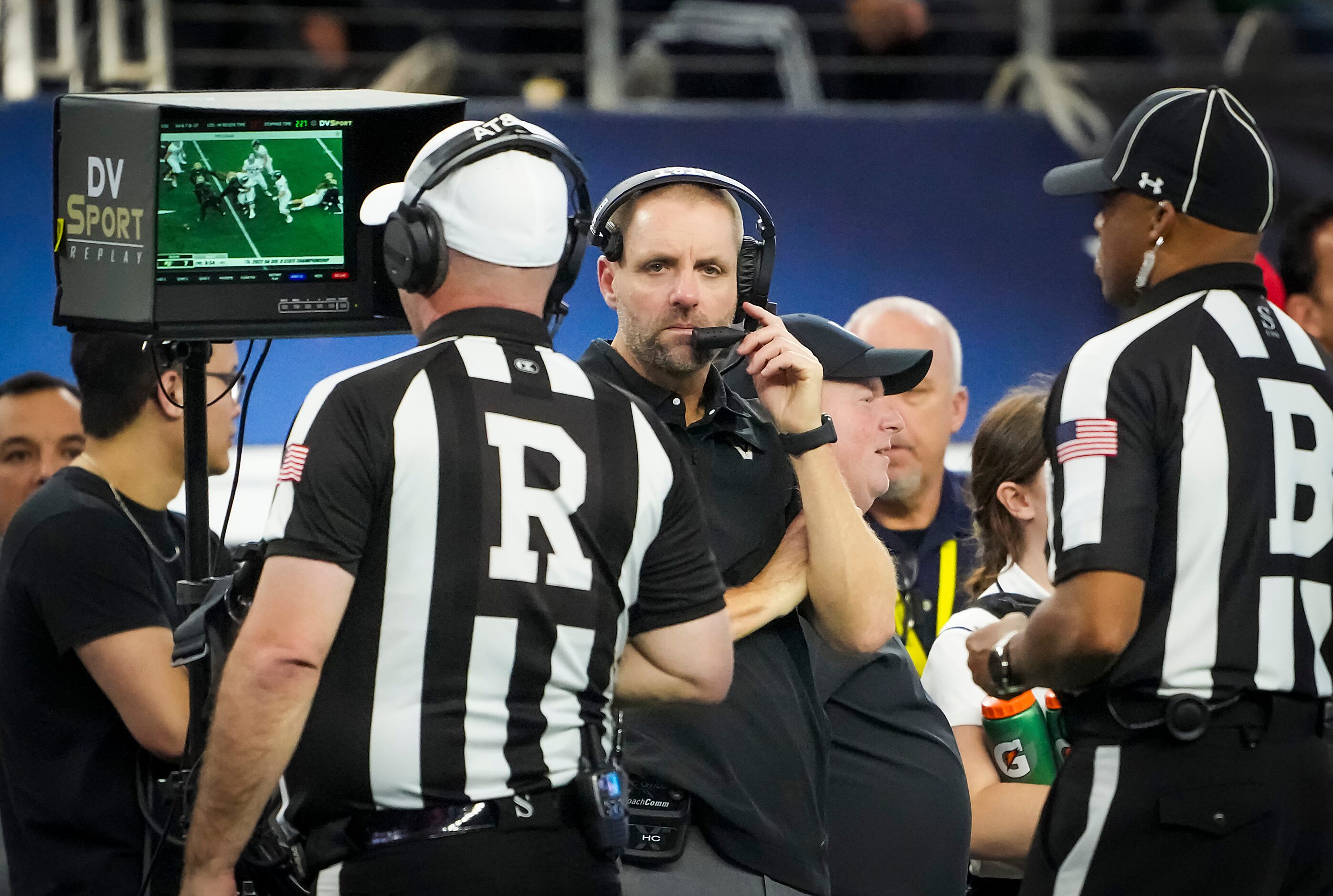 Officials review a replay of a fumbles by Austin Vandegrift quarterback Brayden Buchanan...