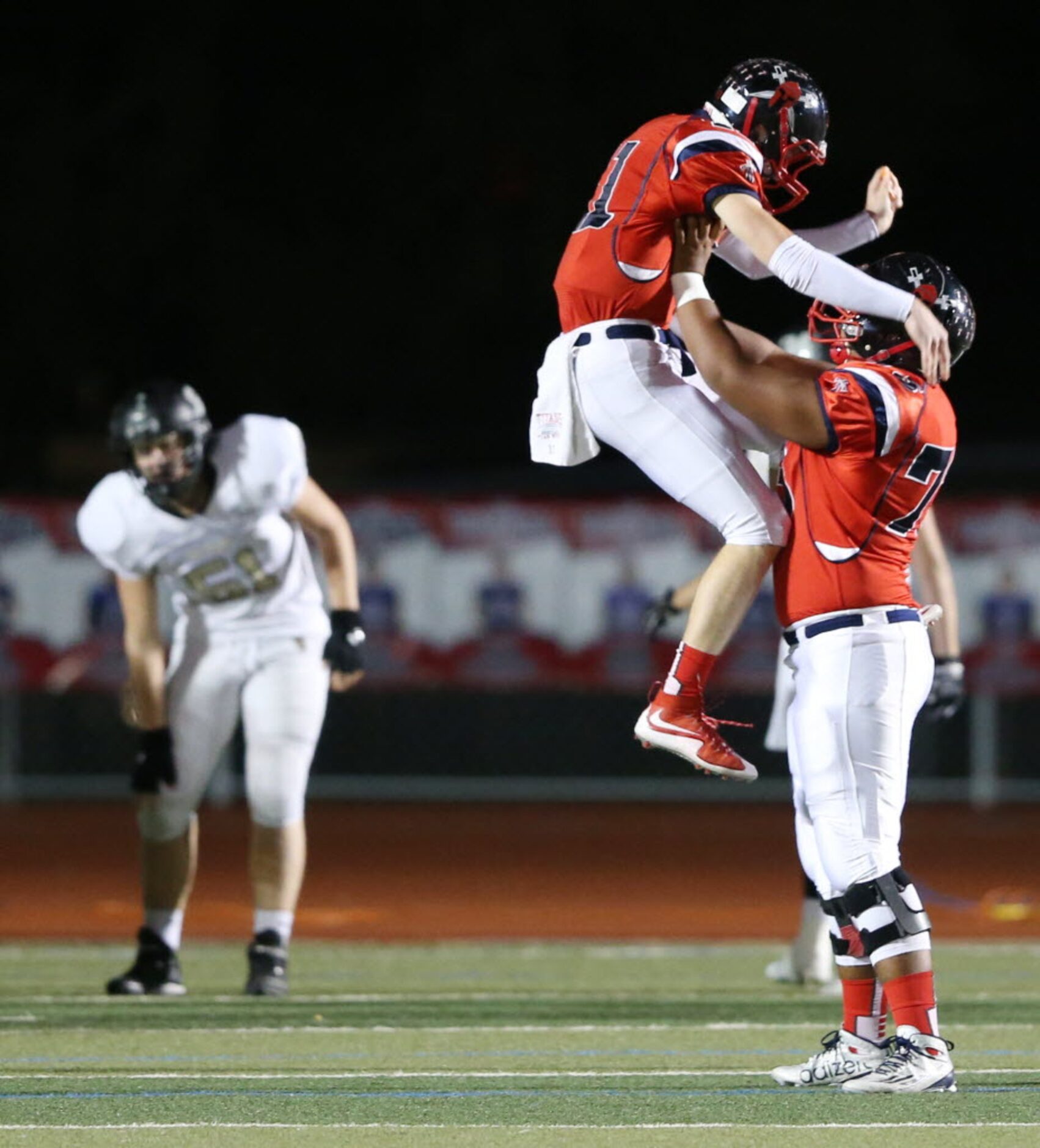 Frisco Centennial's Court Walker (11) celebrates a 78 yard touchdown run with teammate Zain...