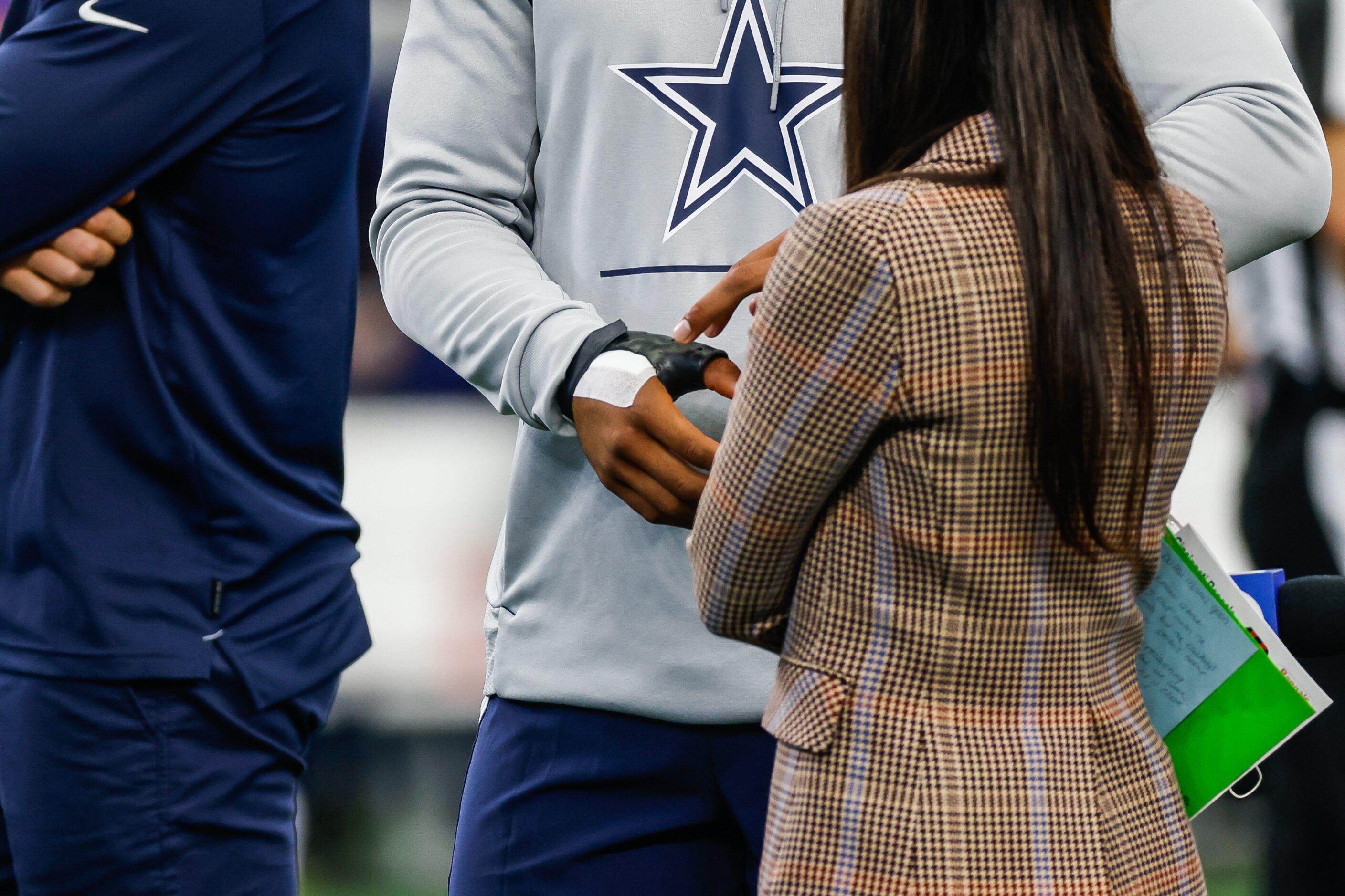 Dallas Cowboys quarterback Dak Prescott (4) shows his hand injured during warmup before the...