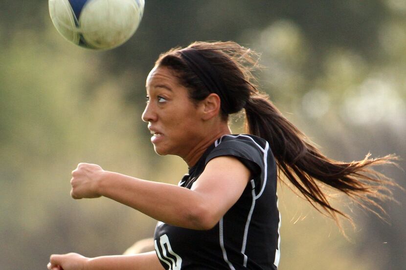 Plano West forward Tori Gates (10) keeps her focus as she heads the ball toward the...