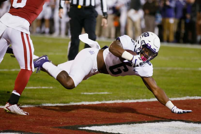TCU running back Darius Anderson (6) dives into the end zone for a touchdown in front of...