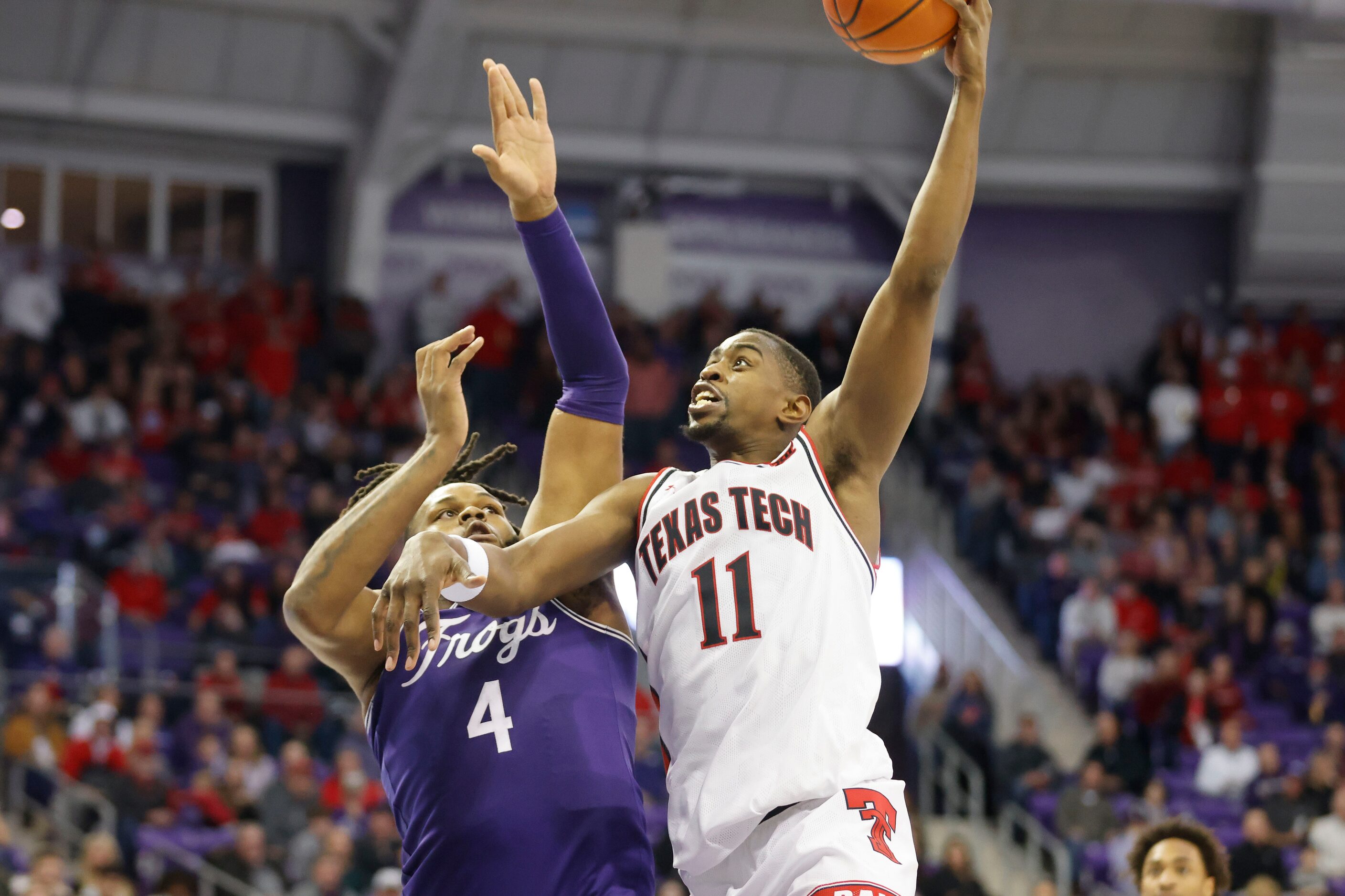 Texas Tech forward Bryson Williams (11) scores on TCU center Eddie Lampkin (4) during the...