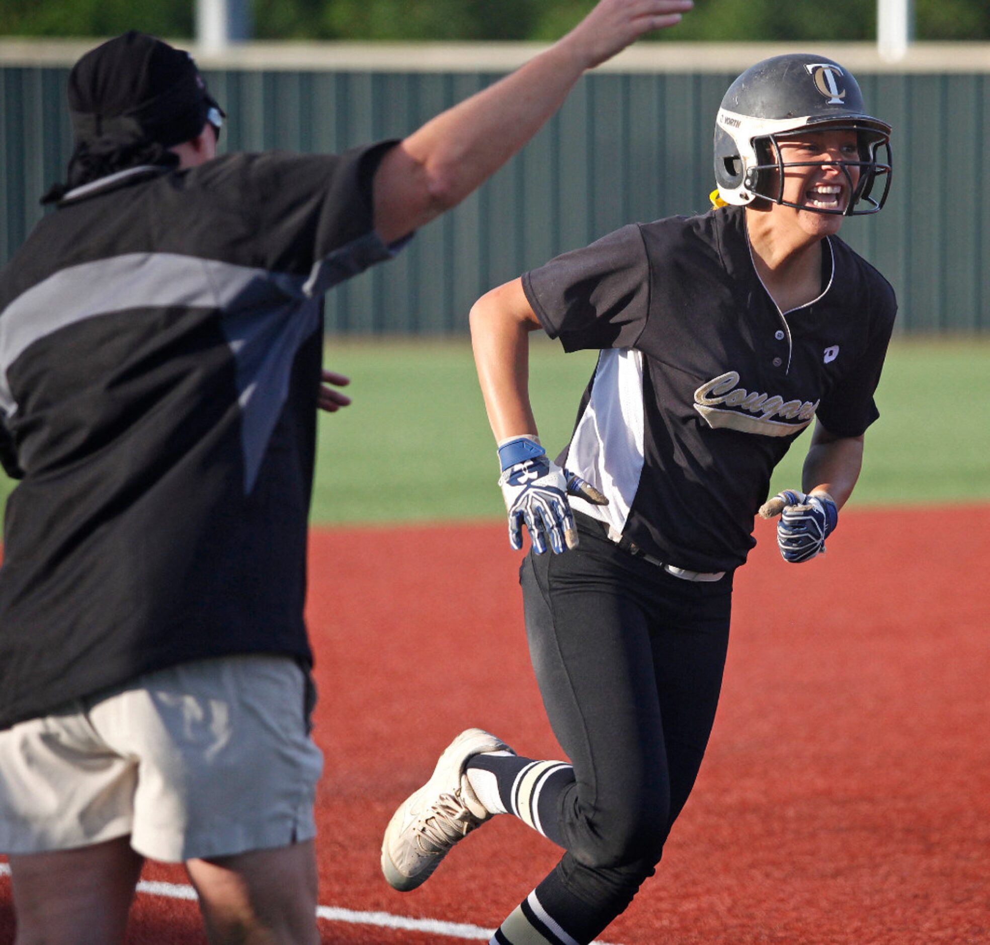 The Colony shortstop Jayda Coleman (24) runs past her mother, head coach Deana Coleman as...