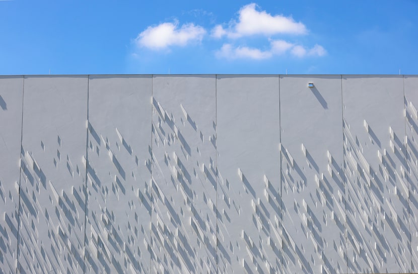 The sun casts shadows on the exterior surface of the newly opened Crow Museum. 